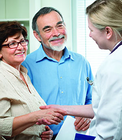 A family doctor counseling a senior couple on general health matters