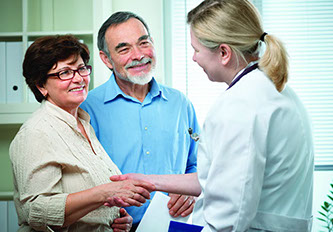 A family doctor counseling a senior couple on general health matters