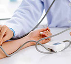 Hands of a patient and of a cardilogist measuring the blood preassure